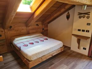 ein Schlafzimmer mit einem Bett im Dachgeschoss in der Unterkunft La Maison. Il Nido dell'Aquila in Bardonecchia