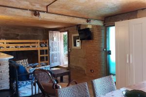 a living room with chairs and a table and a bed at Sweet Stone in Vigo +43 photos