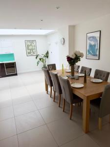 a dining room with a wooden table and chairs at Central London Luxury 4 Bed Home in London
