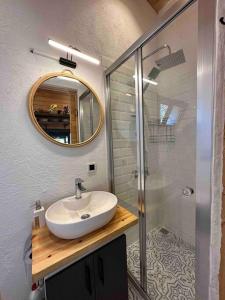 a bathroom with a sink and a shower with a mirror at Tiny House Patara in Kas