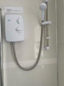 a shower in a bathroom with a shower head at Middlecroft in Chesterfield