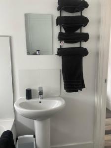 a bathroom with a sink and a mirror and towels at Middlecroft in Chesterfield