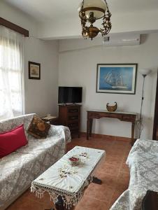 a living room with a couch and a table at Amadrias by the sea in Vergia