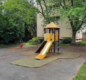 a playground with a slide in a park at Appartement lumineux pour 6 in Hérouville-Saint-Clair