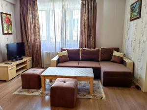 a living room with a couch and a coffee table at Sofia hotel apartments in Sofia