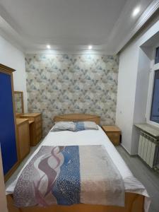 a bedroom with a bed in a room at Apartment near the sea in Batumi