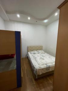a small bedroom with a bed in a room at Apartment near the sea in Batumi