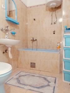 uma casa de banho com uma banheira, um lavatório e um WC. em apartman berane em Berane