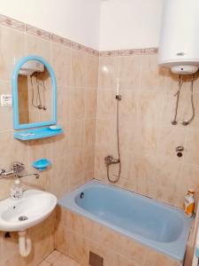 a bathroom with a tub and a sink at apartman berane in Berane