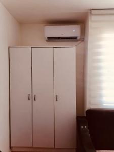 a white cabinet with a television on top of it at apartman berane in Berane