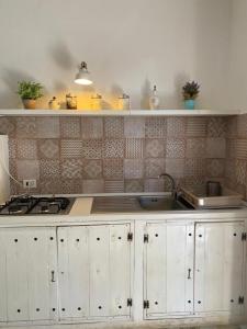 a kitchen with a sink and a counter top at Salenti..amo in Pulsano