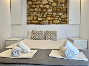 una camera da letto con un letto e asciugamani di The Beach House - Apartments & Studios ad Áfitos