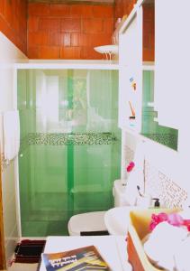 a bathroom with two toilets and a glass shower at Barra da Tijuca Rio de Janeiro ilha da gigoia in Rio de Janeiro