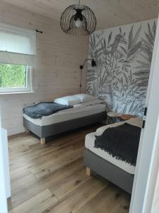 Postel nebo postele na pokoji v ubytování Morska Szyszka & Leśne SPA
