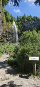 a bench sitting in front of a waterfall at Villa Duchatel Appt 2/4 pers in Le Mont-Dore