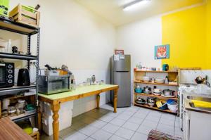 a kitchen with a counter and a refrigerator at Lilén multiespacio hospedaje in Valparaíso