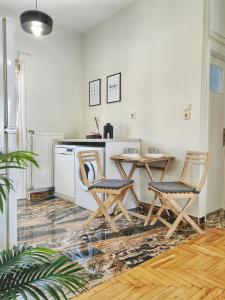 a kitchen with a table and chairs in a room at Funky Boho Kallithea Loft in Athens