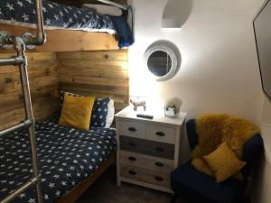 a bedroom with a bunk bed and a dresser at The Coop in Castle Douglas