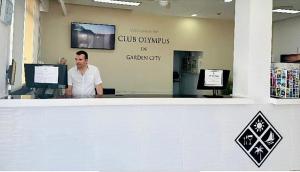 a man standing at a counter in a store at AleSol Tenerife in Playa Fañabe +25 photos