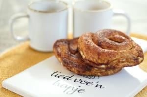 two donuts sitting on top of a white plate at La Casita Middelburg in Middelburg +9 photos