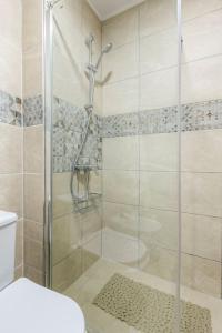 a shower with a glass door in a bathroom at Cosy Apartment in Los Cristianos 5min to the ocean in Los Cristianos