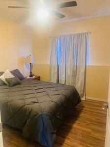 a bedroom with a bed and a window with a ceiling fan at Luxury 2 bedroom rental place with a fireplace in Colorado Springs