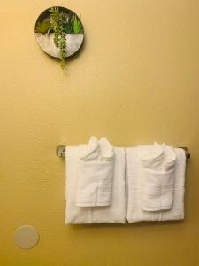 a group of white towels hanging on a towel rack at Luxury 2 bedroom rental place with a fireplace in Colorado Springs