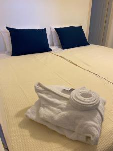 a white towel sitting on top of a bed at Delta Apartment in Chrissi Akti