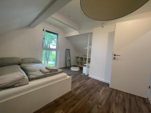 a bedroom with a bed and a large window at City house with garden, free parking in Graz
