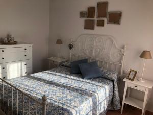 a bedroom with a bed with a blue pillow on it at ALOJAMIENTO RURAL EL CASTAÑO in Fuenteheridos