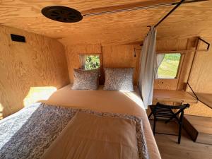 a bedroom in a tiny house with a bed at Ubytování Maringote 