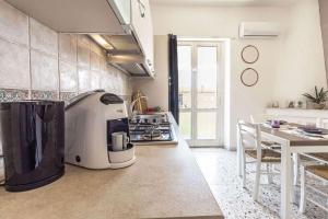 a kitchen with a coffee maker on the counter at Elizabeth Guest House in Arzachena