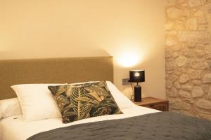 a bedroom with a bed with a pillow and a lamp at Villa Mara in Villanueva de Arosa