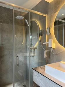 a bathroom with a shower and a sink at Hotel Harmshof Bispingen in Bispingen +59 photos