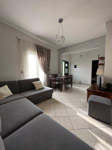 a living room with a couch and a dining room at Saranda Apartments in Sarandë