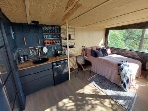 a bedroom with a bed and a sink in a room at fjord : oslo in Nordstrand