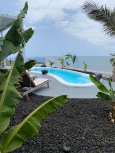 a resort pool with a view of the ocean at Tagoro Sunset View & Heated Pool Tenerife in Santa Cruz de Tenerife