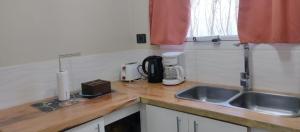 a kitchen with a sink and a counter top at Departamento DON ALBERTO in El Calafate