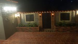 a brick house with a black door at night at Hotel Boutique Casa Antigua in San Vicente de Chucurí