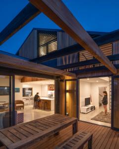 a house with a view of the living room and dining room at Twin Peaks Beach House - New Plymouth Holiday Home in New Plymouth