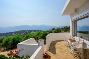a patio with a view of the ocean from a house at Althea Villas by breathtaking view in Agios Nikolaos
