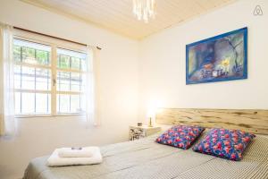 a bedroom with a bed with two pillows on it at Cozy Country House in Colonia - Uruguay in Real de San Carlos