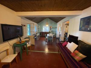 a living room with a couch and a table at Cozy Country House in Colonia - Uruguay in Real de San Carlos