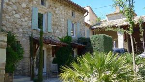 a stone house with plants in front of it at Gites au Château des Estubiers in Les Granges-Gontardes
