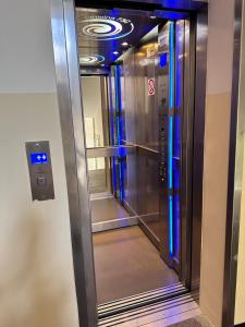 een lift in een gebouw met blauwe lichten erop bij Nice Stay Apartment Centrum in Warschau