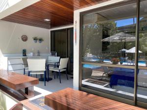 a patio with a table and a dining room at Nannai Residence Flat in Porto De Galinhas