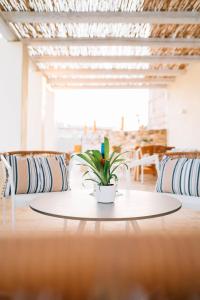 a table with a potted plant on top of it at The Windmill Villa in Lampi