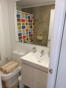 ビーニャデルマールにあるDepartamento 2D y 2B Viña del marのバスルーム(トイレ、洗面台、鏡付)
