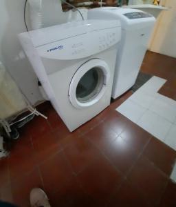 a washing machine in a bathroom with a tile floor at La Rojarilla in San Miguel de Tucumán