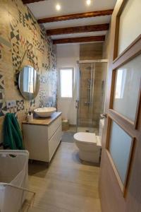 a bathroom with a toilet and a sink and a shower at Finca Artiles in Las Palmas de Gran Canaria